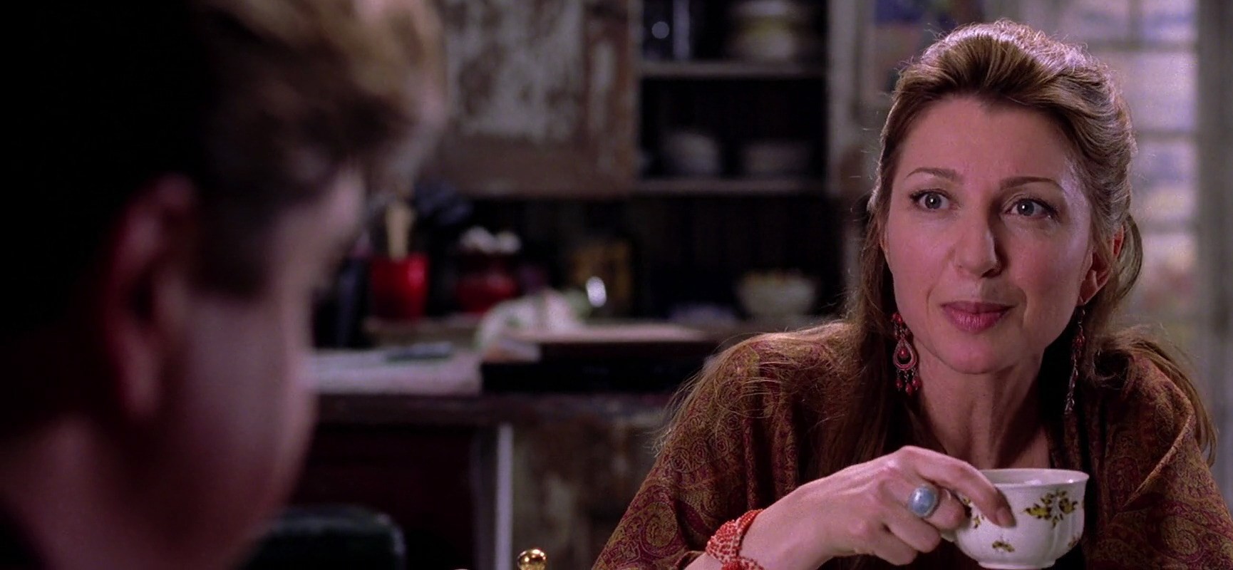 A woman drinks tea with a man in Spider-Man 2.