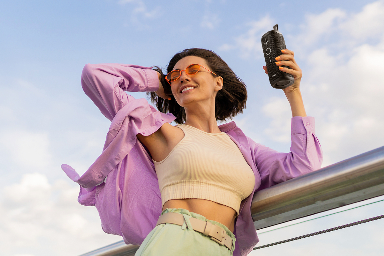 The Tribit StormBox 2 Bluetooth speaker being held by a woman.