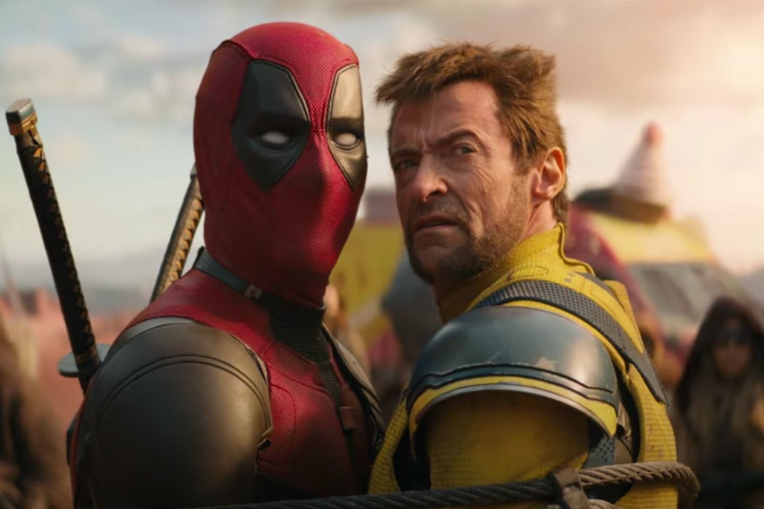 Deadpool and Wolverine stare back in the same direction.