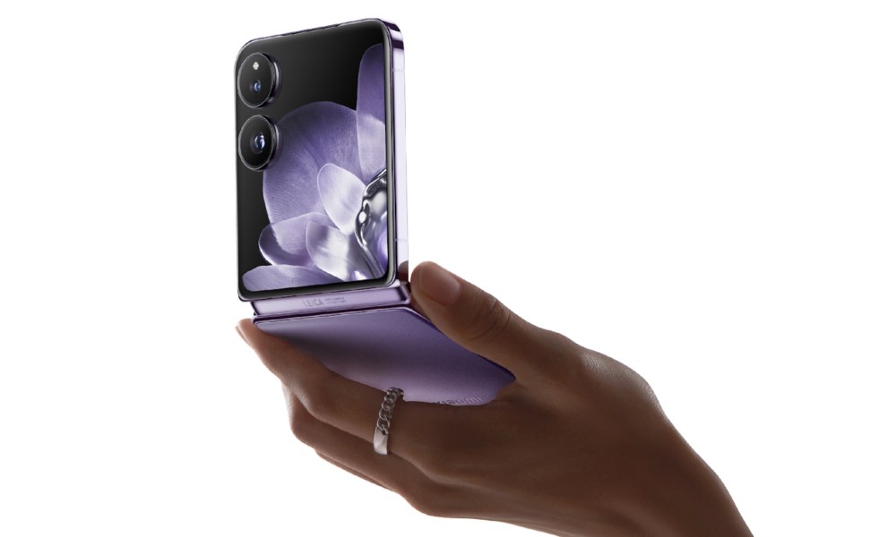 Xiaomi Mix Flip purple clamshell foldable phone in hand.