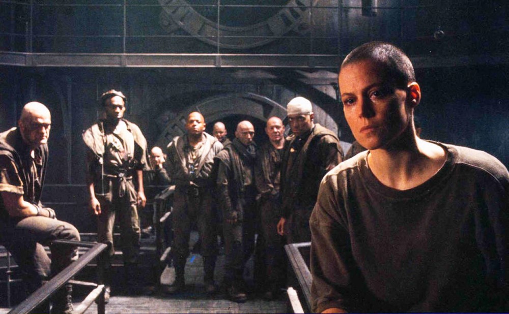 Ripley and a group of men stand in Alien 3.