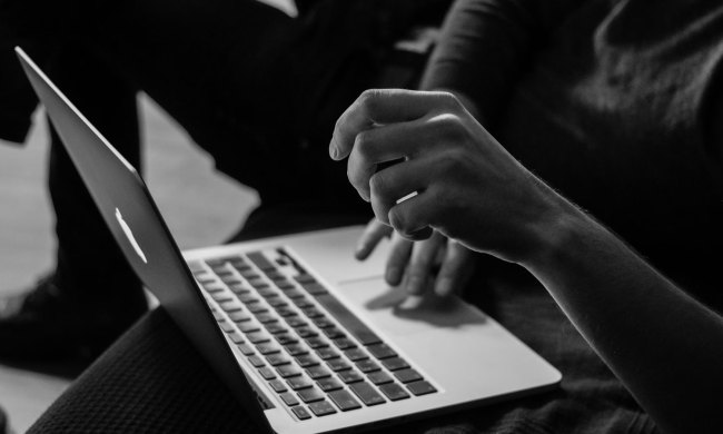 Woman using a touchpad on a laptop.