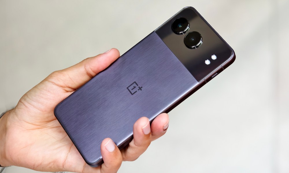 OnePlus Nord 4 Midnight black with metal back held in hand.