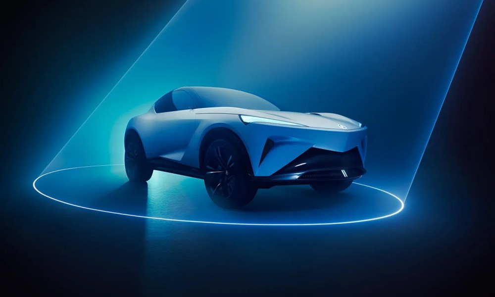 The Acura Performance EV Concept car appears under a spotlight.