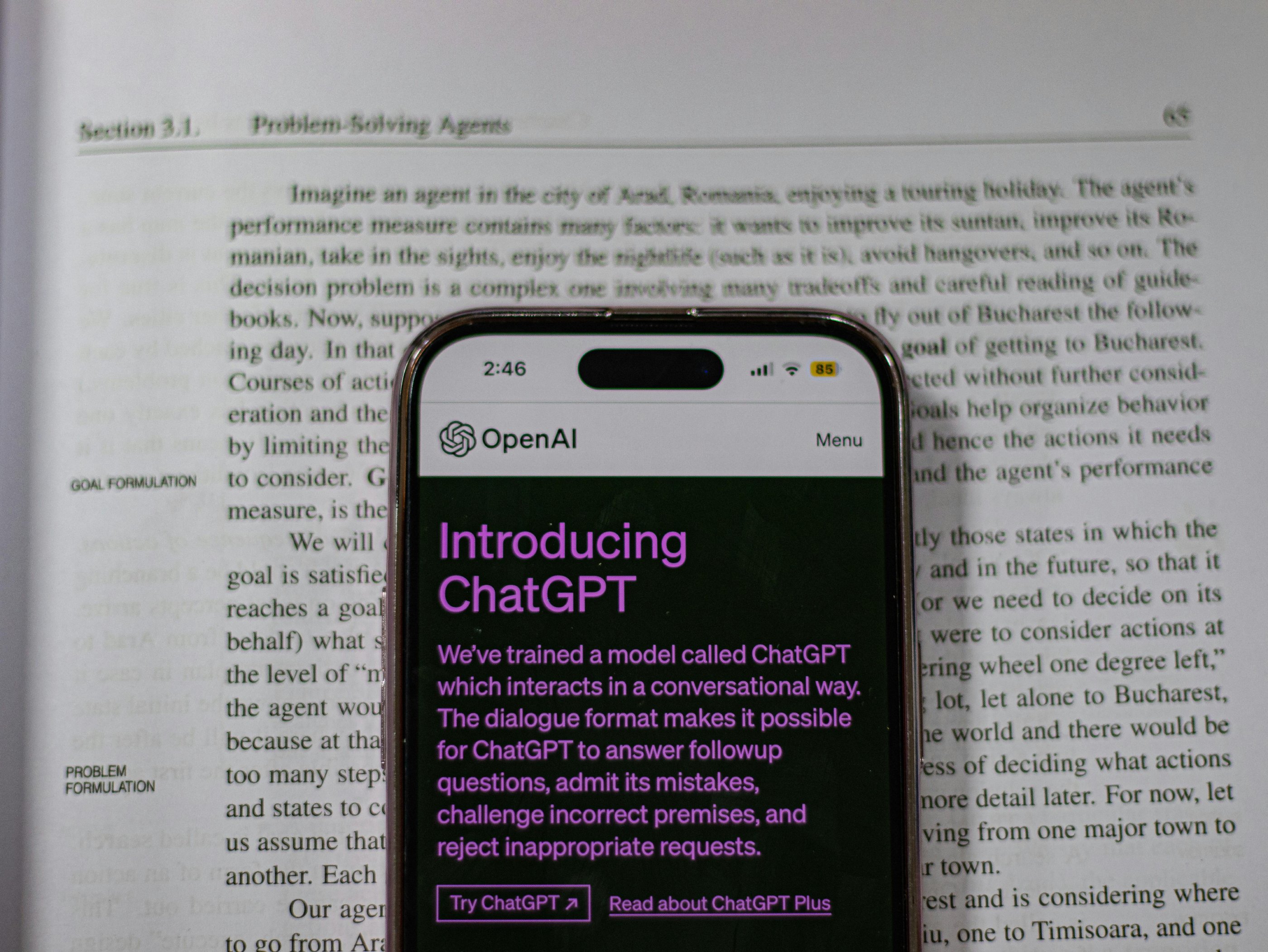 chatGPT on a phone on an encyclopedia