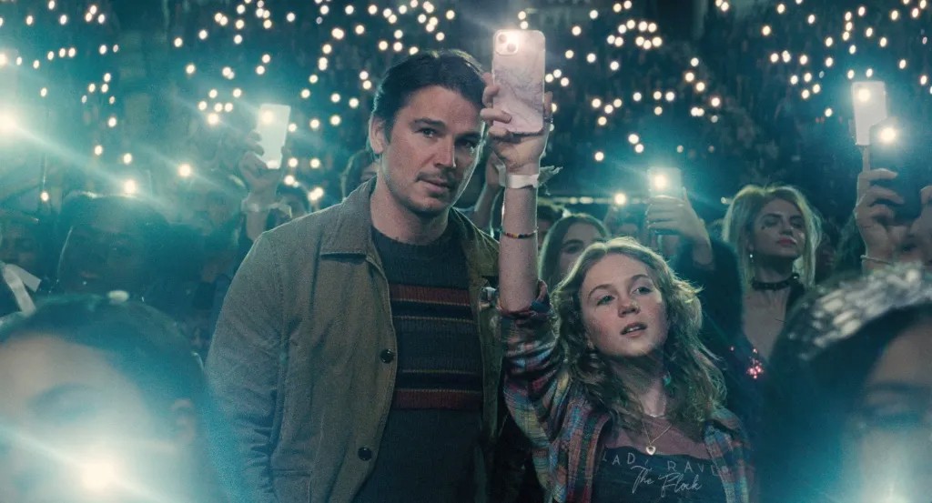 A man and a girl watch a concert in Trap.