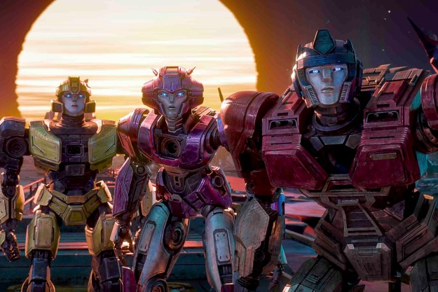 Optimus Prime stands with two other Autobots in Transformers One.