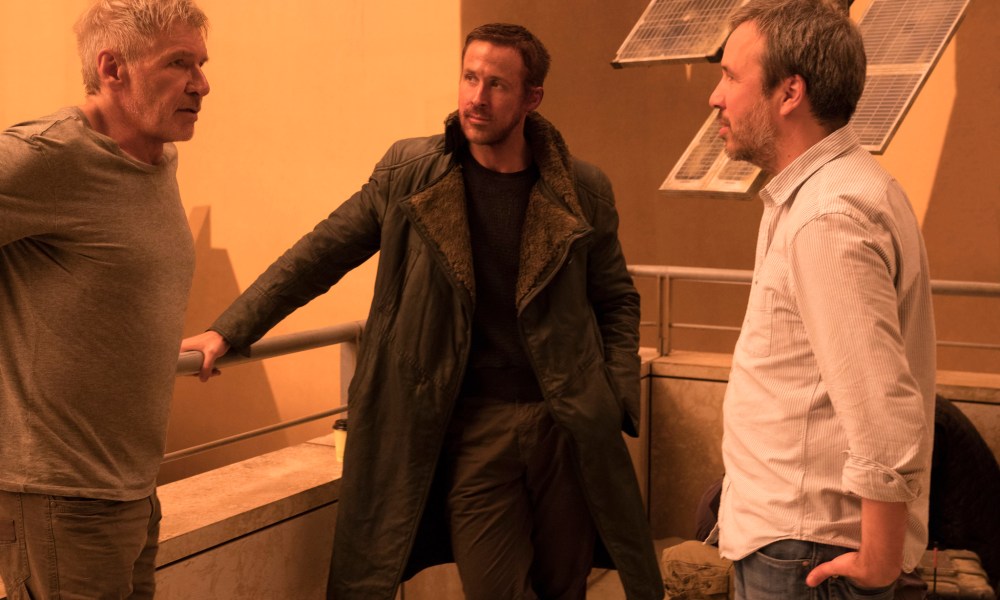 Denis Villeneuve stands with Harrison Ford and Ryan Gosling on the set of Blade Runner 2049.