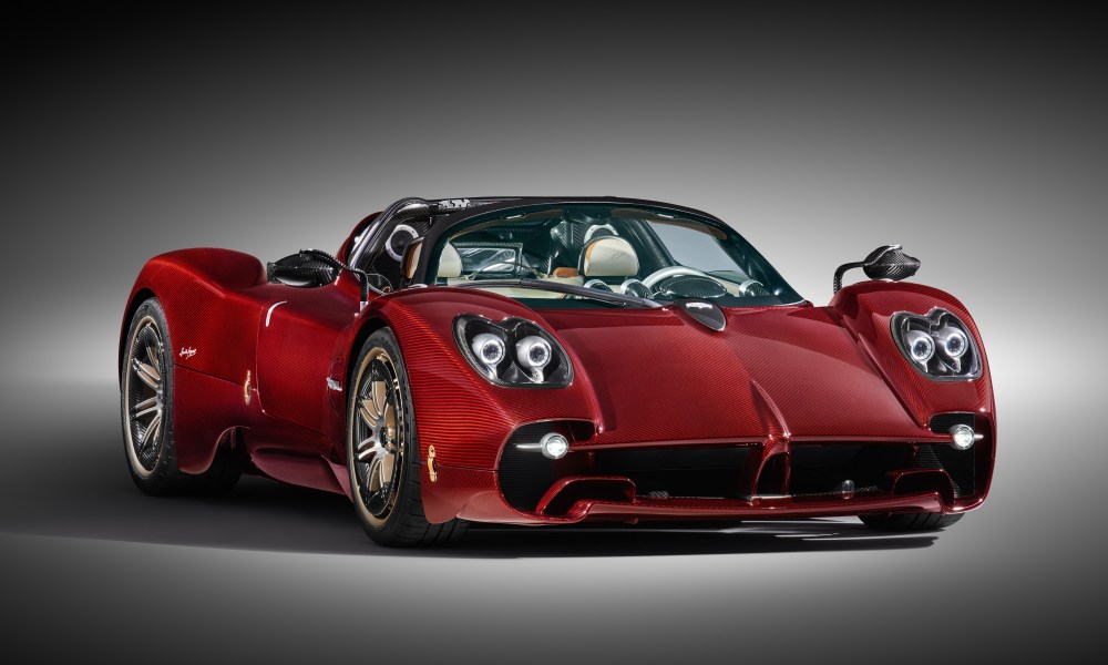 Red Pagani Utopia Roadster in a spotlight on a white background