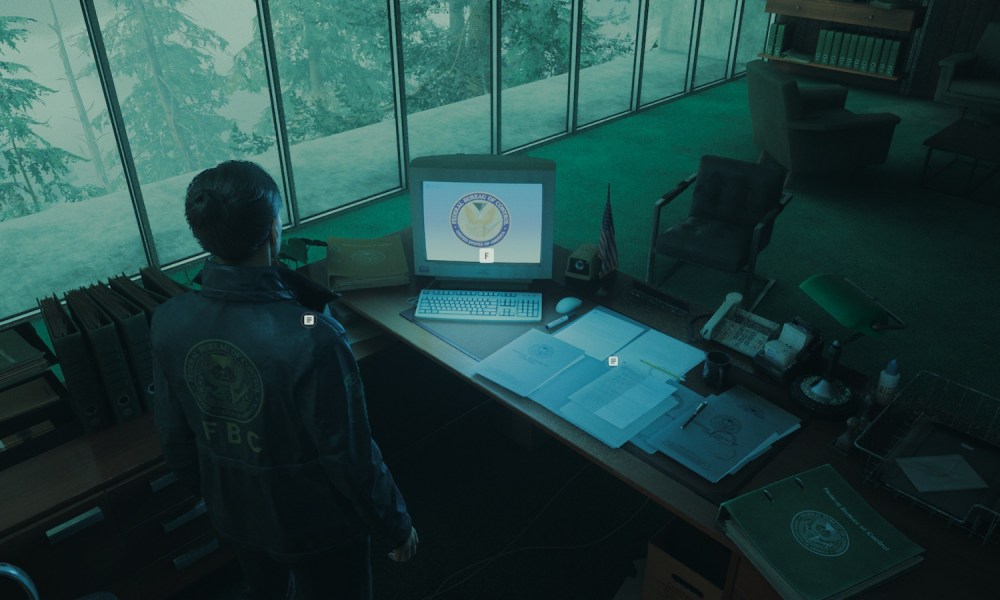 Agent Estevez in Alan Wake 2 looking at a computer.