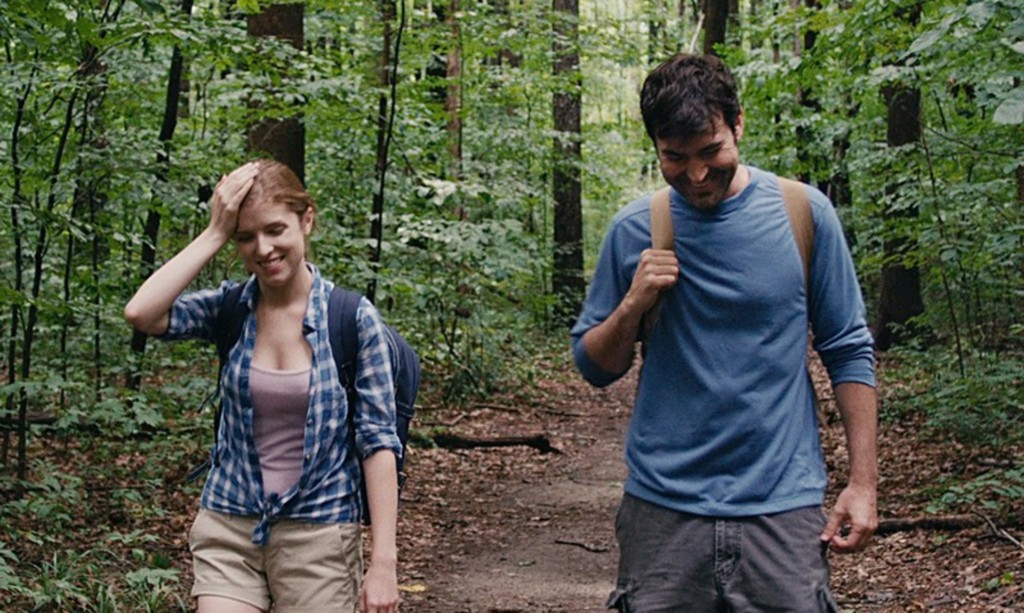 A man and a woman walk in a forest in Drinking Buddies.