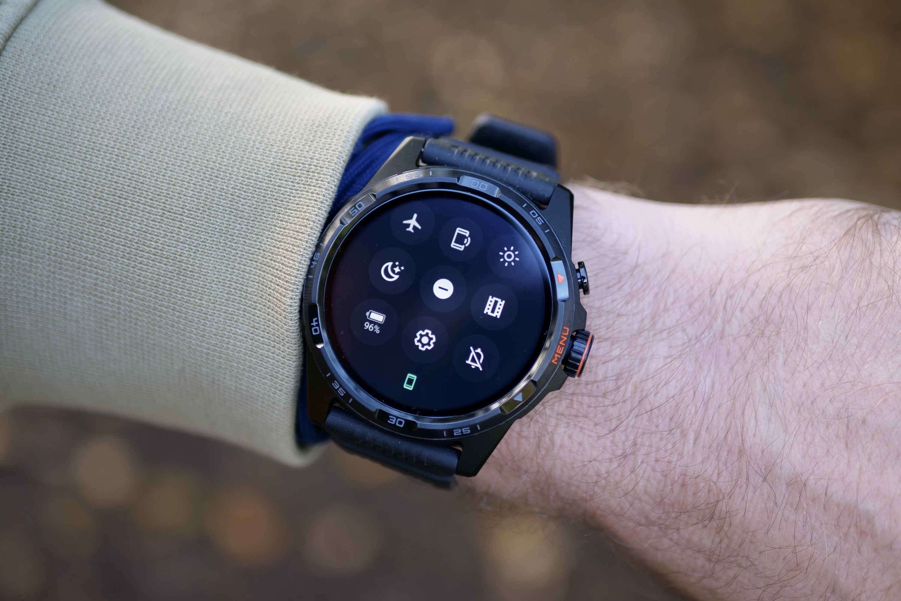 A person wearing the Mobvoi TicWatch Atlas, showing the quick access menu.