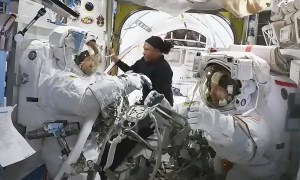 NASA astronaut Jeanette Epps (center) assists NASA astronauts Mike Barratt (left) and Tracy C. Dyson inside the Quest airlock.